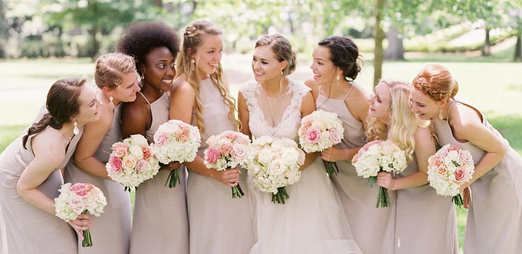 A photo of a bridal party wearing jewelry that complements their dresses.