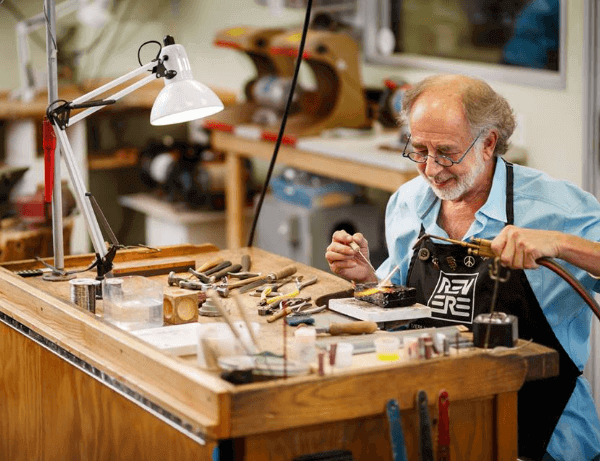 professional jeweler working on a ring in their workshop