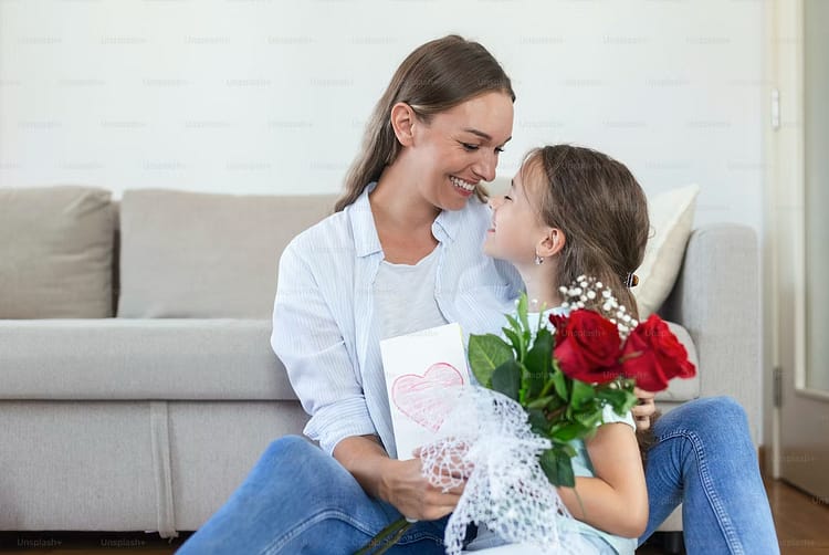 Mother and Daughter with bouquet of flowers with card