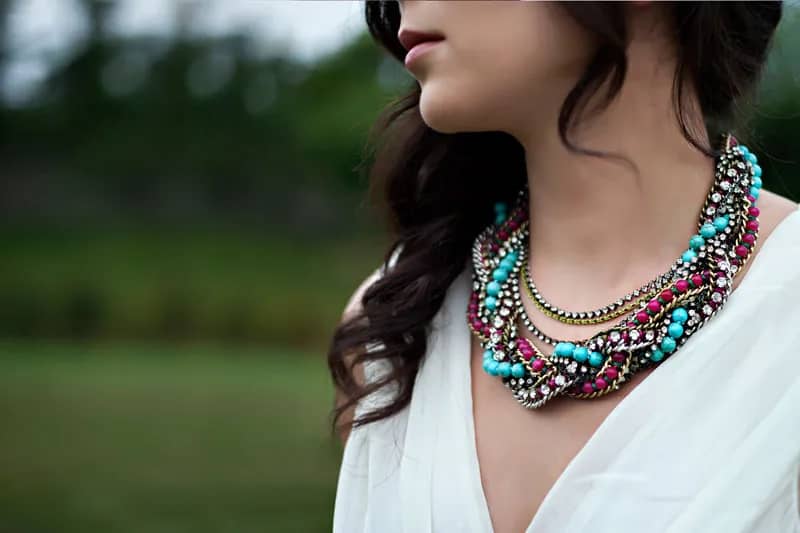 woman wearing a statement necklace