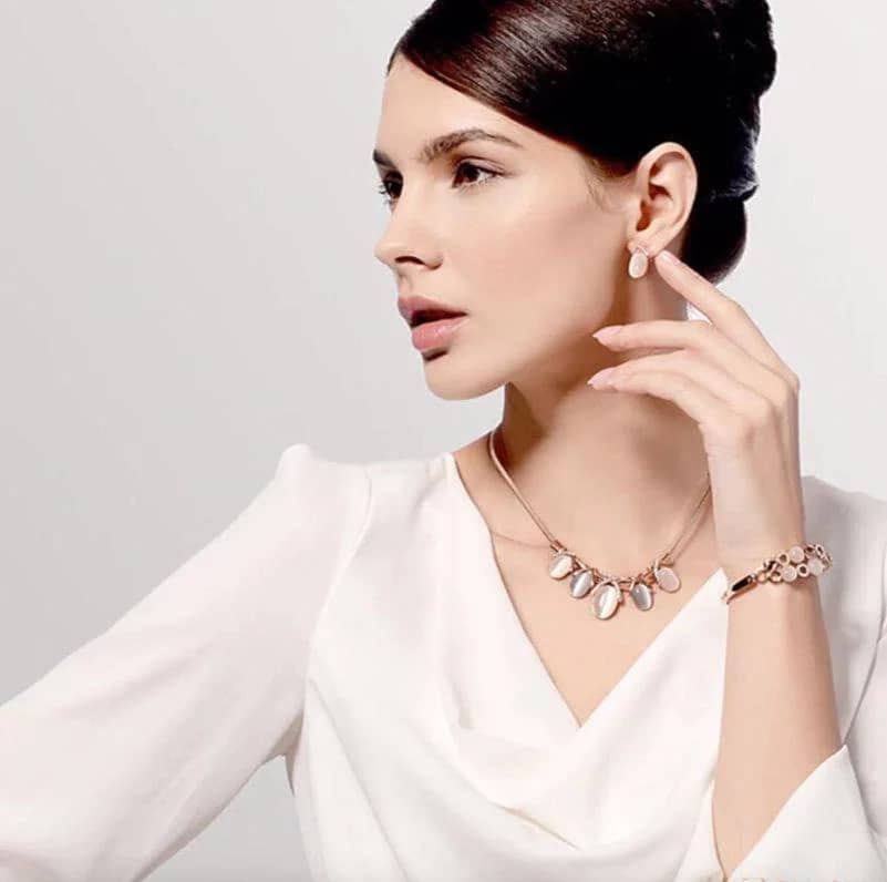 woman wearing a necklace, bracelet, and earrings.