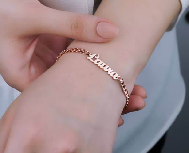 A close-up of an engraved bracelet, with intricate designs and lettering.