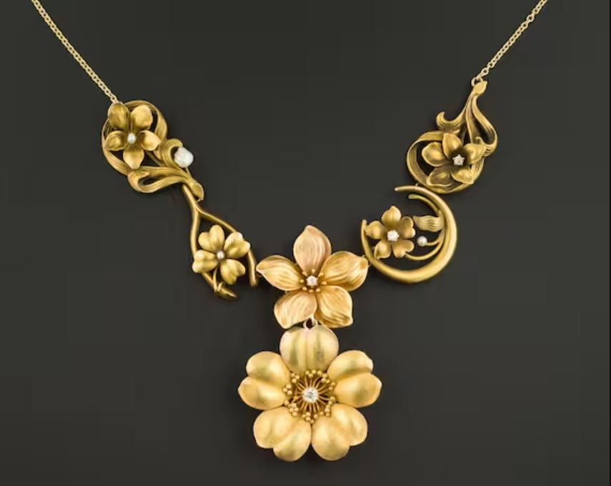 A vintage Art Nouveau necklace featuring intricate floral designs