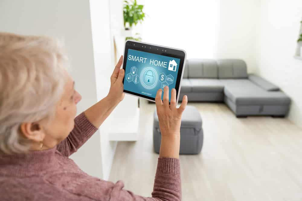 An elderly woman using a home automation system