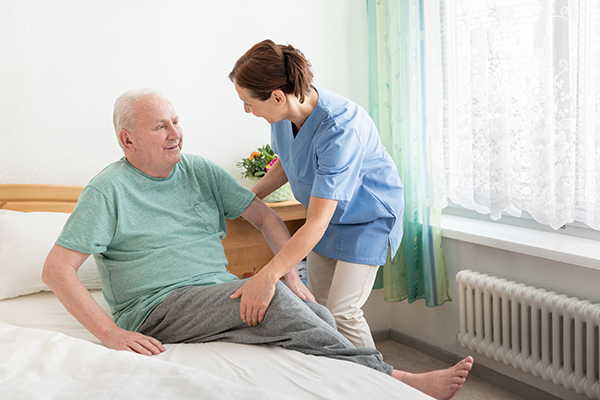 caregiver assisting an elderly person