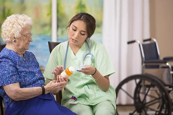 a healthcare provider discussing medication with a senior patient