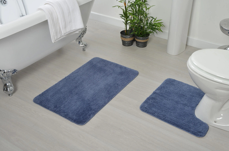 A clean and dry bathroom with a bath mat and adequate ventilation.