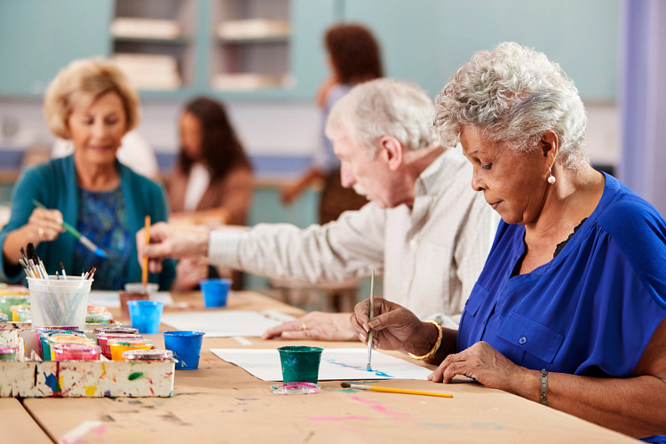 A group of elderly people participating in a hobby class