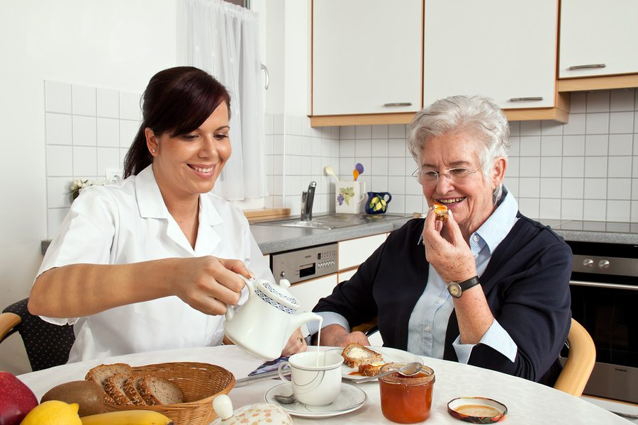 Caregiver assisting a senior with meal preparation